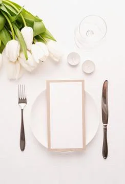 Mock up menu frame in restaurant or cafe. Top view of table setting with menu Stock Photos
