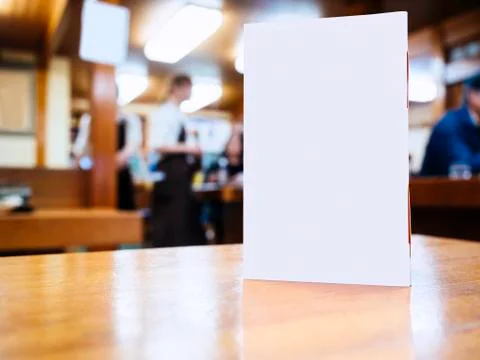 Mock up Menu frame on Table Bar Restaurant Cafe with Blurred people Background Stock Photos