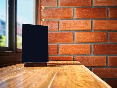 Mock up Menu frame on Table Cafe Restaurant Brick wall background Stock Photos