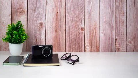 Mock up modern home decor with camera, Houseplant, Phone, Notebook, Glasses.. Stock Photos