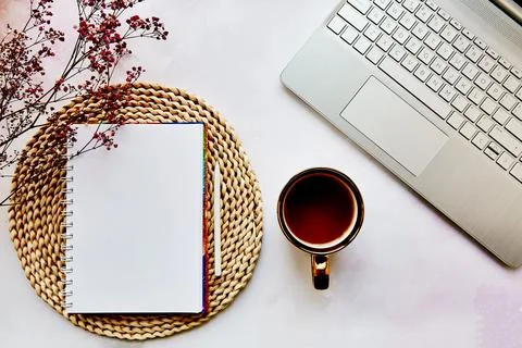 Mock up notepad, laptop, tea cup and gypsophila flower. List of goals, to do Stock Photos