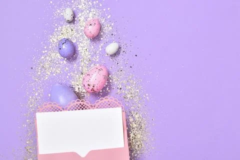 A mock-up of a pink envelope with a blank sheet of paper on a purple backgrou Stock Photos