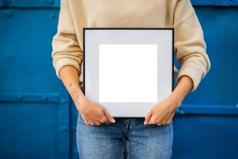 Mock up poster. Minimal template with empty picture frame mock up. Girl holdi Stock Photos