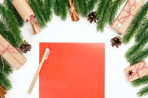 Mock up red empty postcards on white table in frame of Christmas tree branches Stock Photos
