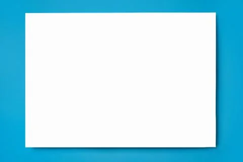 Mock up of a sheet of white A4 paper on a blue background. Top view. Close up Stock Photos