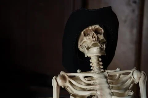 A mock-up of a skeleton in a hat on a dark background with a place for an ins Stock Photos