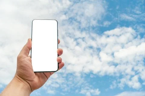 Mock Up smartphone on the background sky. 스톡 사진