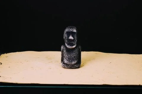 Mock statue from Easter Island. A stone man on the sand. Stock Photos
