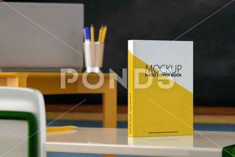Mock up of textbook with blank white cover placed on table near pencil in class PSD Template