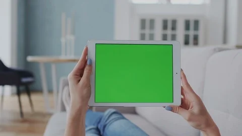 Mock-Up Tracking or Green Screen Display on Tablet PC. Girl Turns Tablet PC from Stock Footage 122417118