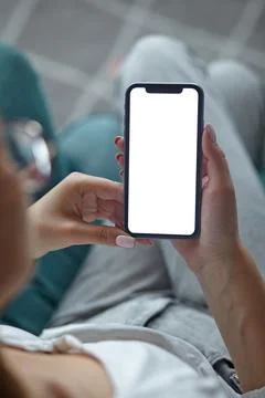 Mock up white screen blank close up mobile phone in woman hands holding Back Stock Photos