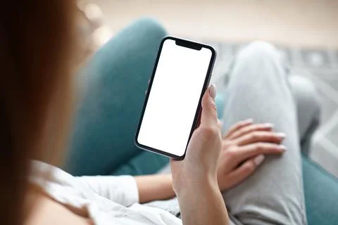 Mock up white screen blank mobile phone in woman hands holding Back view Stock-Fotos