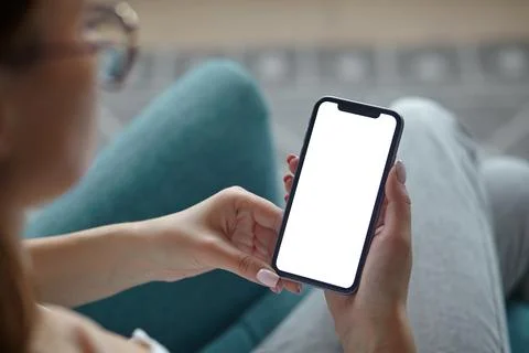Mock up white screen blank mobile phone in woman hands holding Back view Stock Photos