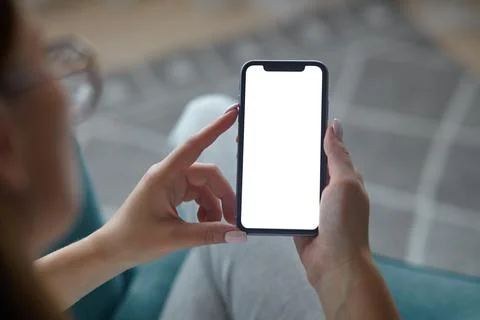 Mock up white screen blank mobile phone in woman hands holding Back view Foto stock