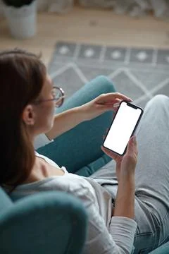 Mock up white screen blank mobile phone in woman hands holding Back view Stock Photos