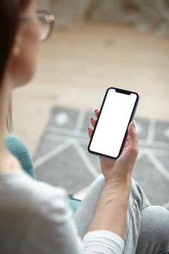 Mock up white screen blank mobile phone in woman hands holding Back view Stock Photos