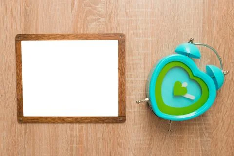 Mock up, on a wooden background with a clock Stock Photos