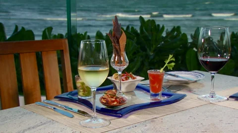Mocktails and appetizers set on table near seashore Stock Footage 57814402