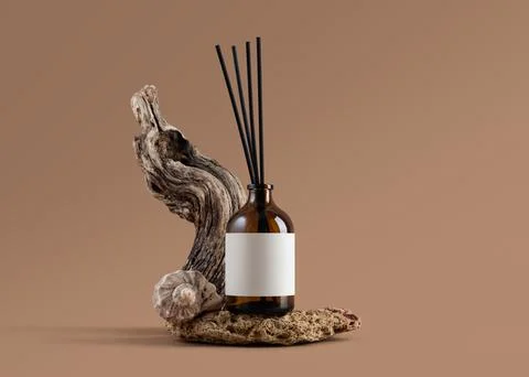 Mockup of amber glass diffuser bottle with blank label, driftwood and seashel Stock Photos