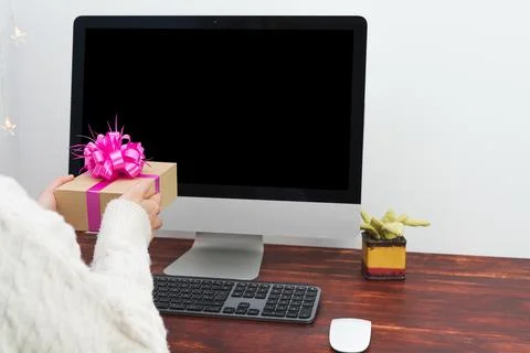 Mockup of a black computer screen and a person delivering a gift Stock Photos