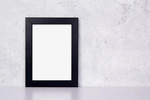 Mockup black frame vertical on table top and wall at home, mock up poster for Foto stock