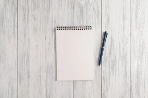 Mockup of a blank notepad and an automatic ballpoint pen Stock Photos