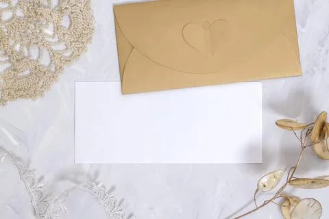 Mockup with blank rectangular sheet of paper and envelope on light table. Stock Photos