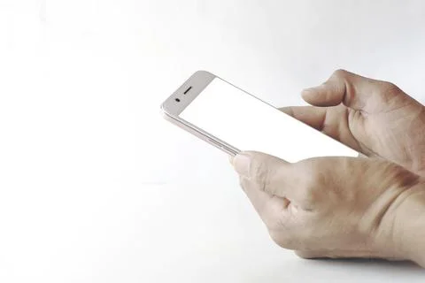 Mockup of a blank white screen cell phone. Man hand holds smartphone using .. Stock Photos