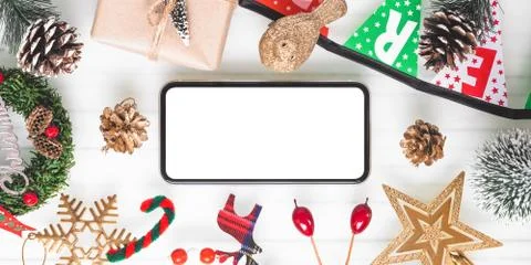 Mockup blank white screen smartphone on white desk background for Christmas a Stock Photos