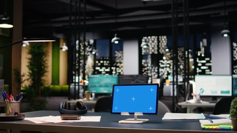 Mockup blue screen tablet with empty office space and glass windows Stock Footage 334039875