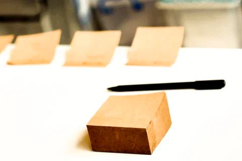 Mockup for check list, empty note paper with pen on brown wood background. Of Stock Photos