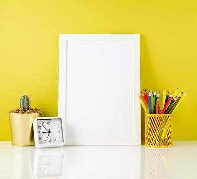 Mockup with clean white frame, colored pencils on the bright yellow background Stock Photos