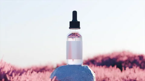 Mockup of clear serum dropper bottle with black cap set in vibrant landscape Stock Footage 322544044