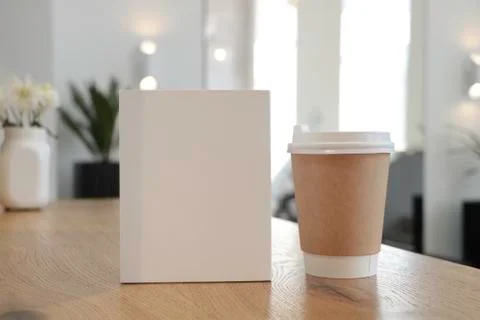 Mockup of a coffee cup and a white book 2 Stock Photos