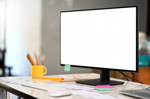 Mockup computer big blank screen on a professional designer desk in a comfo.. Fotos Stock