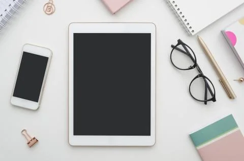 Mockup. Digital tablet with blank screen, smartphone and notepad on table. Woman Stock Photos