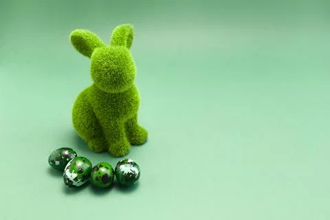 Mockup Easter green bunny, rabbit with blue colored chicken quail eggs on blue Stock Photos