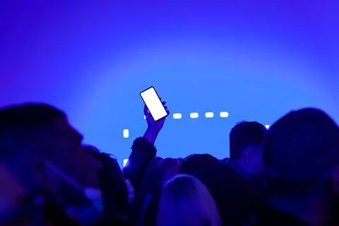 Mockup empty white smartphone screen, people in night club party concert Stock Photos