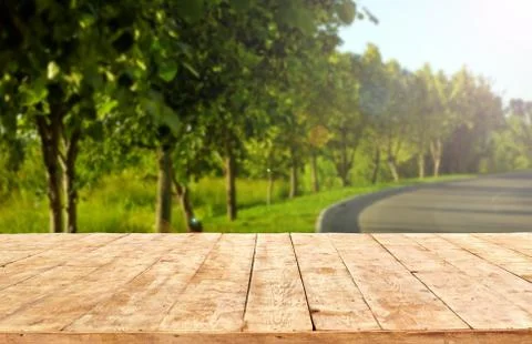 Mockup. Empty wooden deck table with foliage bokeh background. Stock Photos