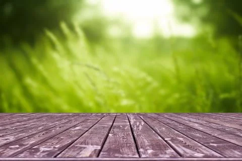 Mockup. Empty wooden deck table with foliage bokeh background. Stock Photos