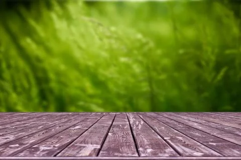 Mockup. Empty wooden deck table with foliage bokeh background. Stock Photos