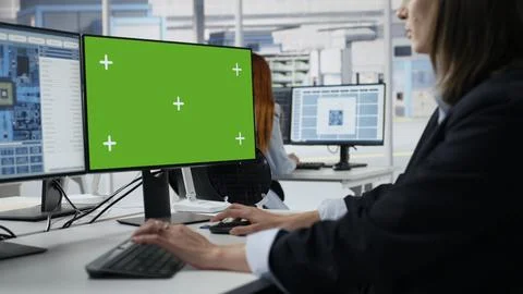 Mockup green screen PC used by woman in microchip factory office Stock Photos