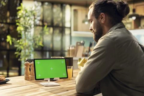 Mockup green screen on tablet in the kitchen with natural light Stock Photos