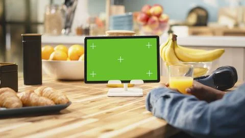 Mockup green screen on tablet in the kitchen with natural light Stock Photos