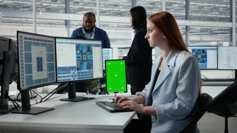 Mockup green screen tablet use by female technician examining microchip circuits Stock Footage 335880518