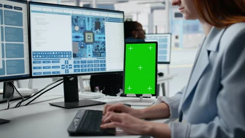 Mockup green screen tablet use by female technician examining microchip circuits Stock Footage 335882269