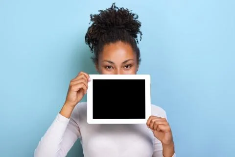 Mockup image of black empty blank screen of tablet in the female hand, peekin Stock Photos