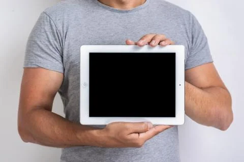 Mockup image of black empty blank screen of ipad in the male hands. - Image Stock Photos