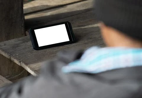 Mockup image blank white screen smart phone.men looking using mobile on woode Stock Photos