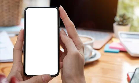 Mockup image blank white screen cell phone.women hand holding texting using Stock Photos
